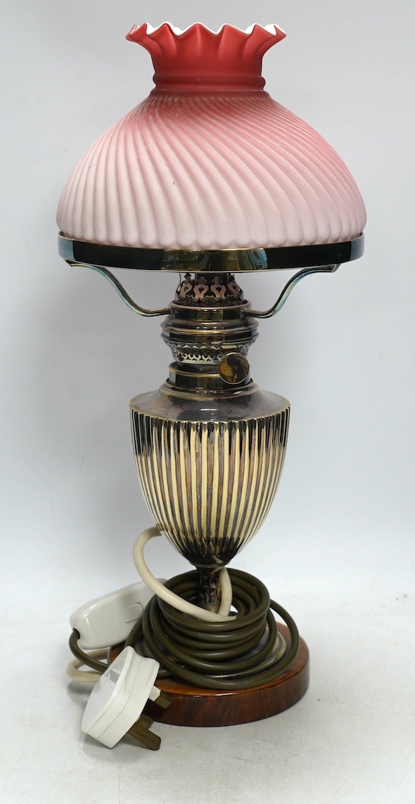 A silver plated table lamp, with a pink satin glass wrythen fluted shade, 41cm high. Condition - shade cracked, lamp untested